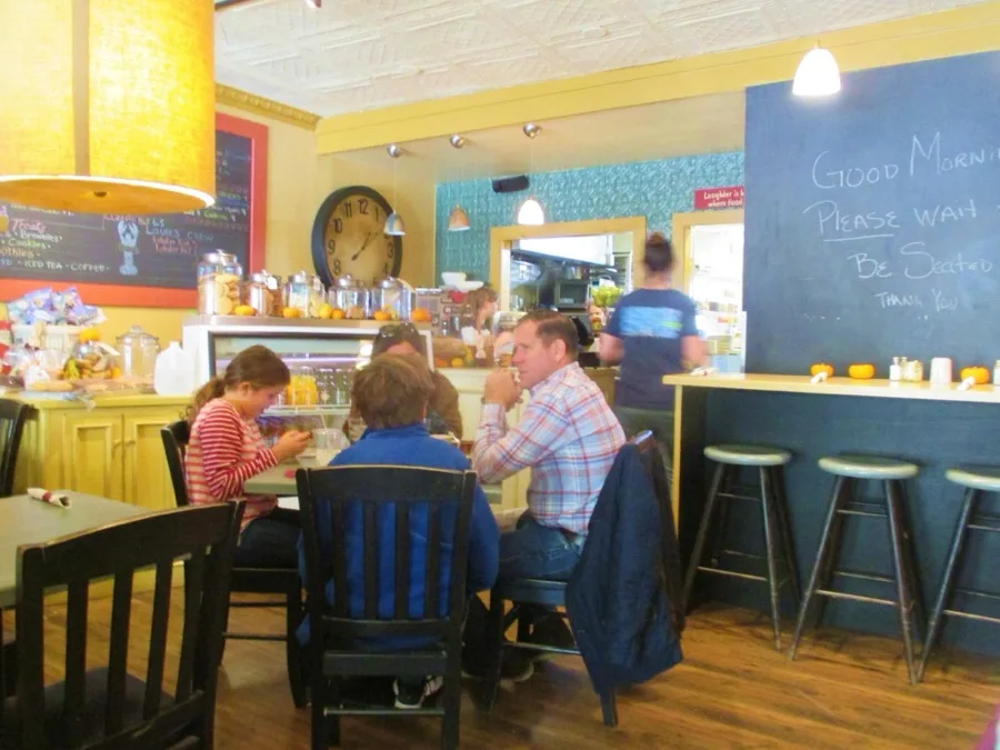 Guests enjoying a meal at the counter and tables inside 5 South Main